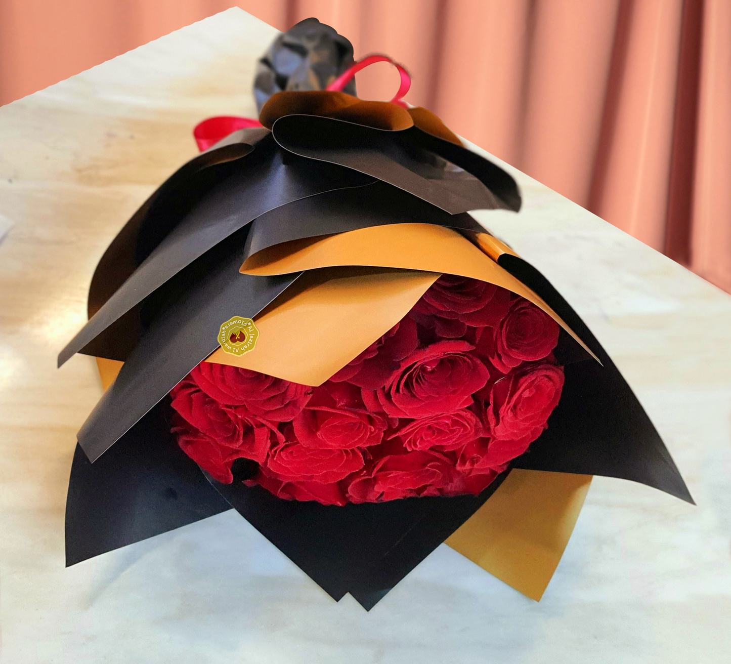 Fresh flower bouquet, rad roses black wrapping