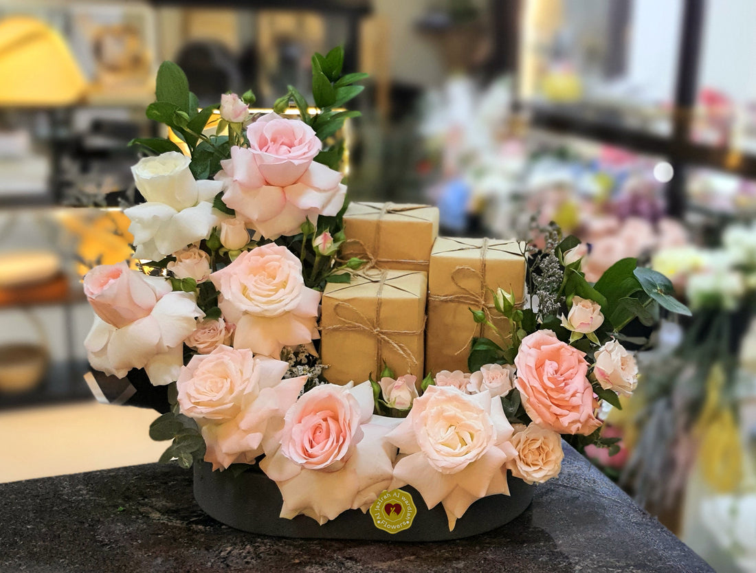 luxury perfume and fresh flower arrangement in a tray