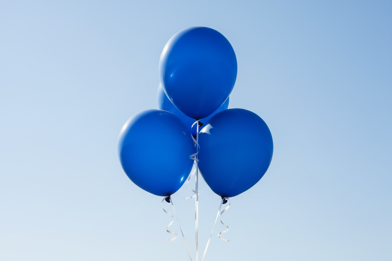 Create a photo of four blue balloons filled with helium gas flying.